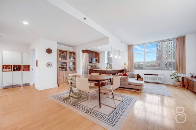 dining area with sink and light hardwood / wood-style floors