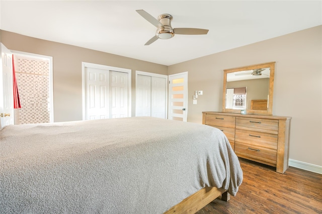 bedroom with ceiling fan, dark hardwood / wood-style floors, and two closets