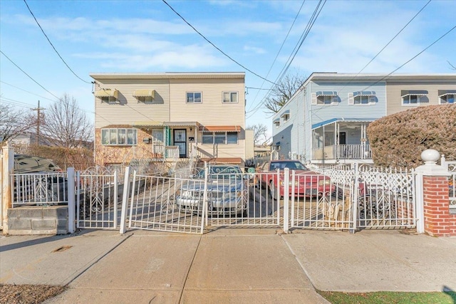 multi unit property with a gate and a fenced front yard