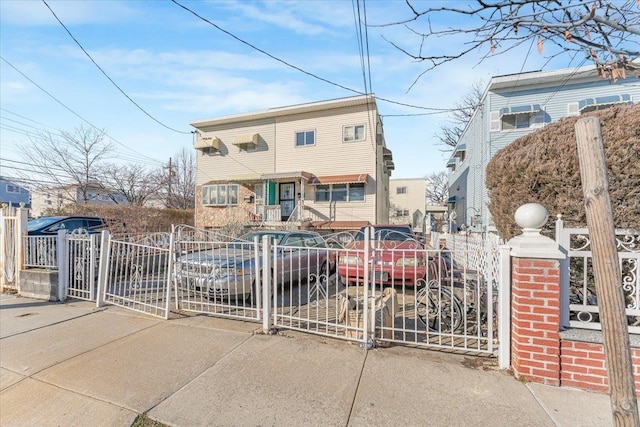 view of front facade featuring fence private yard and a gate