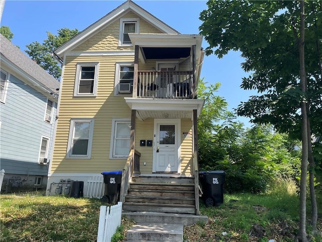 view of front of property featuring a balcony and cooling unit