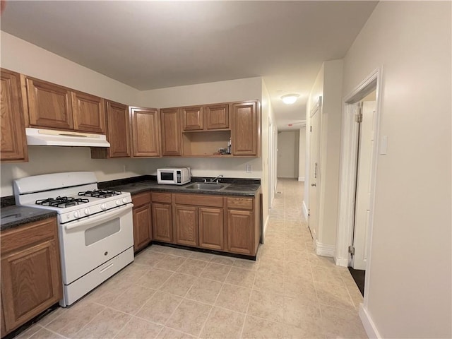 kitchen with sink and white appliances