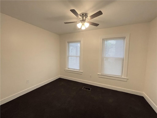 carpeted spare room with ceiling fan