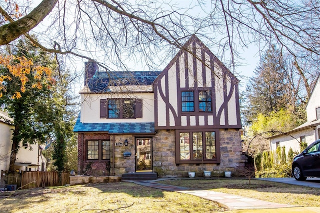 english style home featuring a front lawn