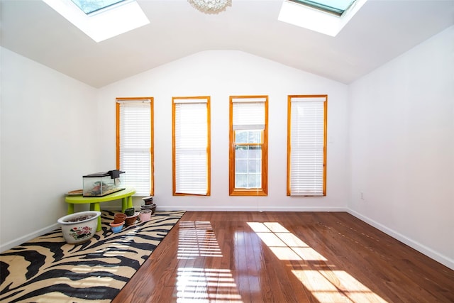 interior space with dark wood-type flooring and vaulted ceiling with skylight