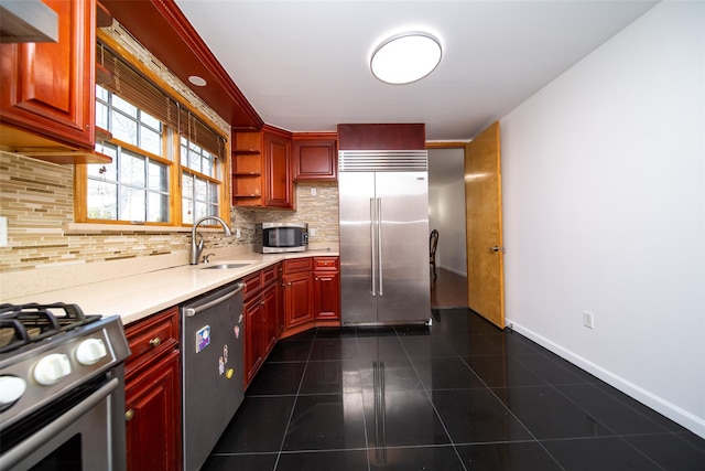 kitchen featuring sink, dark tile patterned floors, backsplash, range hood, and stainless steel appliances