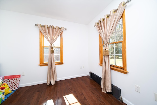 unfurnished room with dark hardwood / wood-style flooring