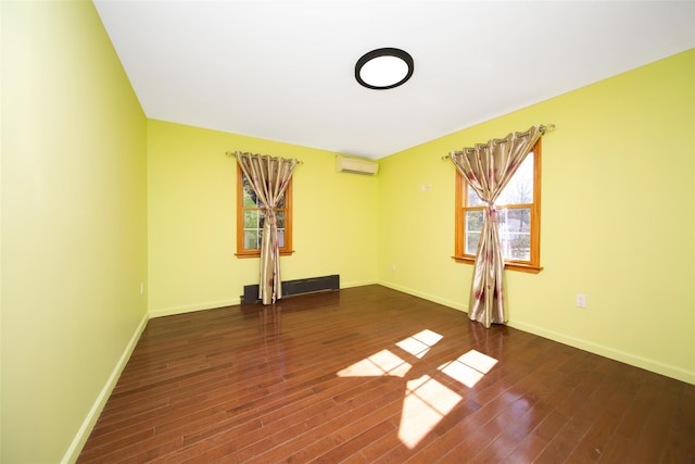 unfurnished room featuring an AC wall unit and dark hardwood / wood-style flooring