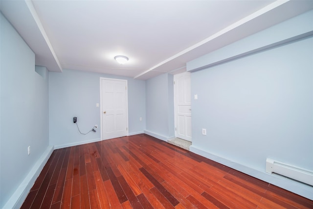 basement with hardwood / wood-style floors and a baseboard heating unit