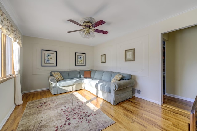 living room with ceiling fan and light wood-type flooring