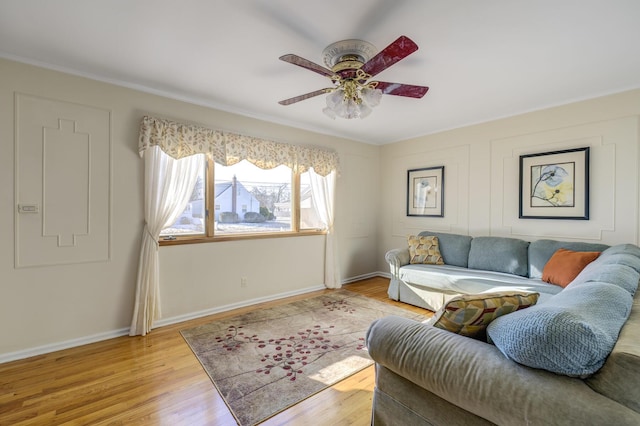 living room featuring light hardwood / wood-style floors and ceiling fan