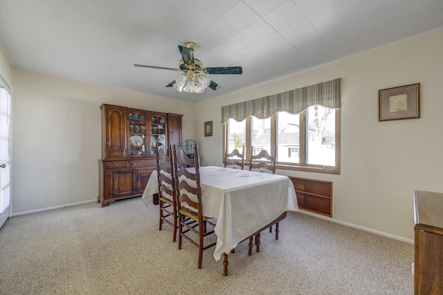 dining room with light carpet and ceiling fan