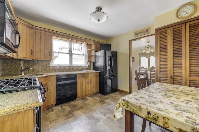 kitchen with sink, decorative backsplash, and black appliances