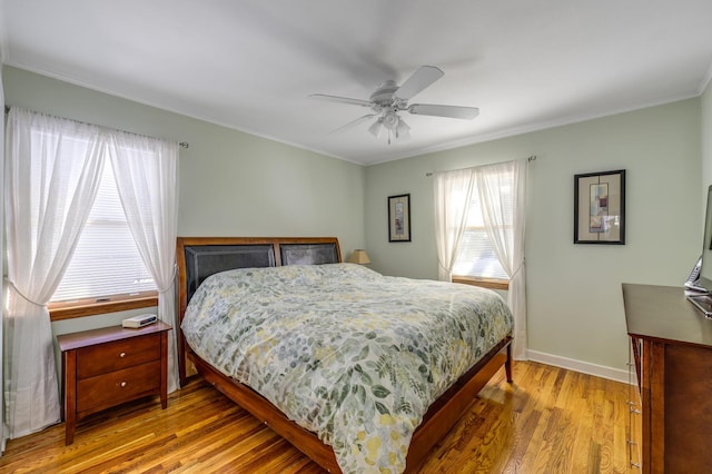 bedroom with crown molding, ceiling fan, and light hardwood / wood-style floors