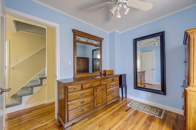 corridor featuring crown molding and light hardwood / wood-style floors