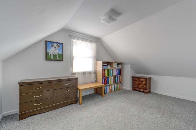 bonus room with vaulted ceiling and light carpet