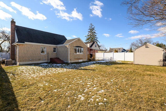 rear view of house with a yard