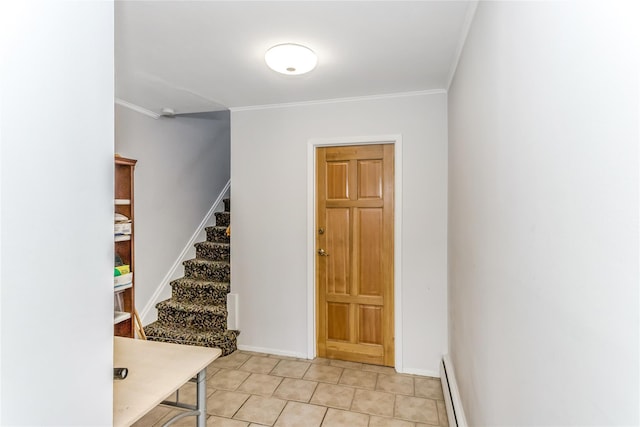 entrance foyer featuring light tile patterned floors, a baseboard radiator, and ornamental molding