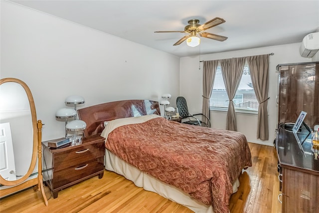 bedroom featuring hardwood / wood-style flooring, ceiling fan, and a wall mounted air conditioner