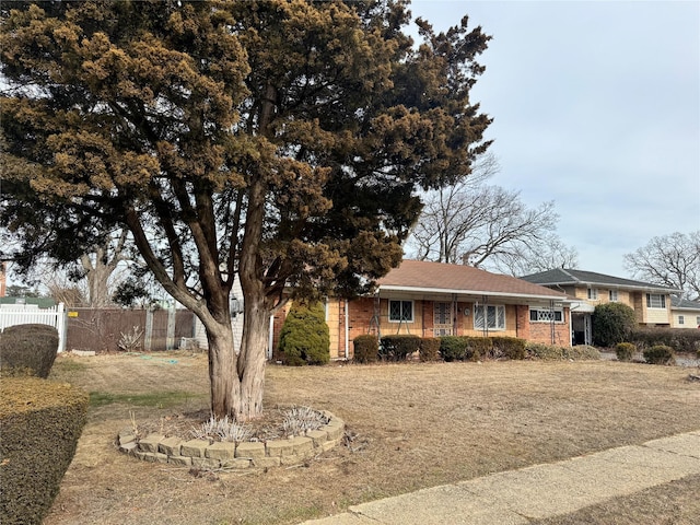 view of front of home featuring fence