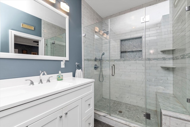 bathroom with a shower stall and vanity