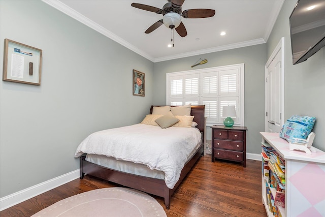 bedroom featuring crown molding, dark wood finished floors, and baseboards