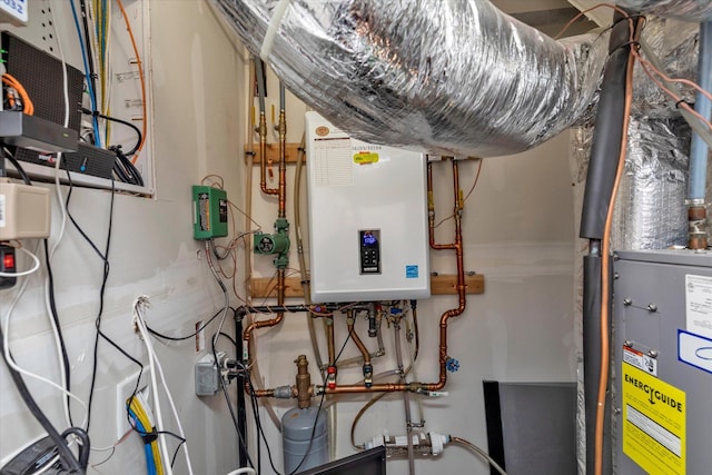 utility room featuring water heater