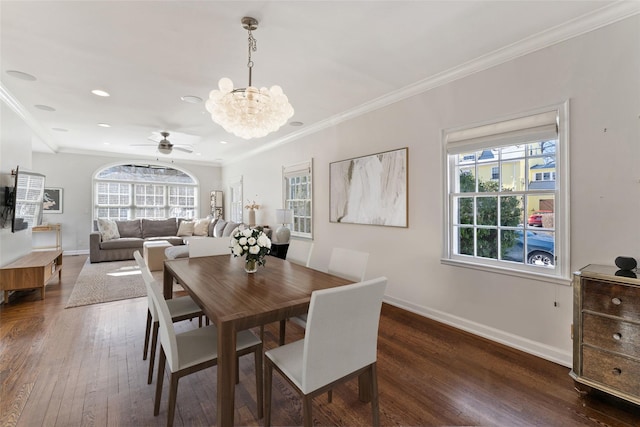 dining space featuring ornamental molding, plenty of natural light, baseboards, and hardwood / wood-style flooring