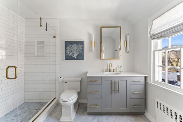 full bath with baseboards, toilet, radiator heating unit, vanity, and a shower stall