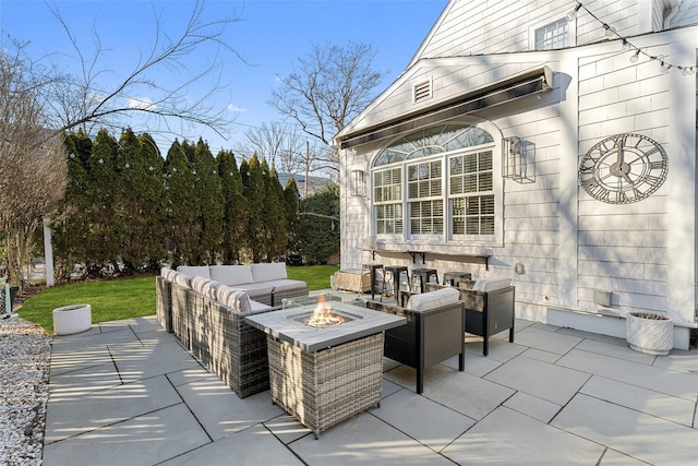 view of patio / terrace with an outdoor living space with a fire pit