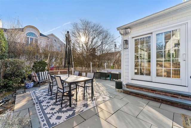 view of patio with outdoor dining area, outdoor lounge area, and fence