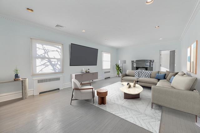 182-61 Avon Rd, Jamaica Estates, NY 11432 - living room featuring ornamental molding, radiator, and light hardwood / wood-style flooring