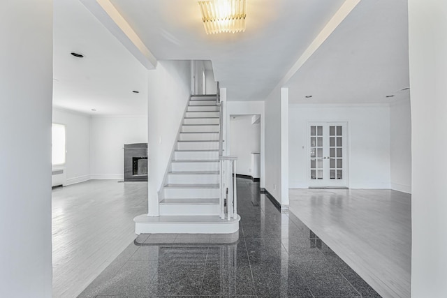 182-61 Avon Rd, Jamaica Estates, NY 11432 - stairway featuring french doors, crown molding, and radiator