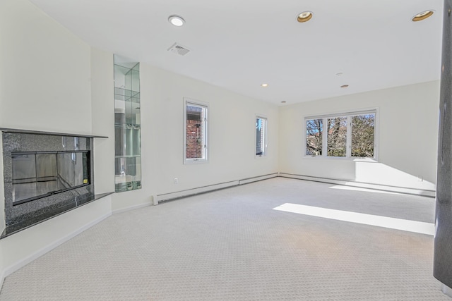 182-61 Avon Rd, Jamaica Estates, NY 11432 - unfurnished living room featuring baseboard heating and light carpet