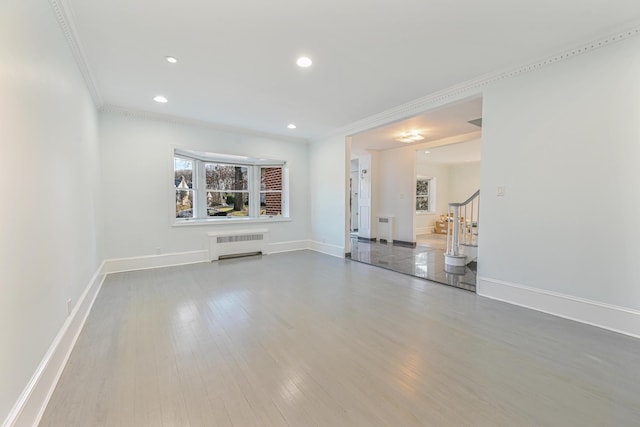 182-61 Avon Rd, Jamaica Estates, NY 11432 - unfurnished living room with hardwood / wood-style floors, ornamental molding, and radiator heating unit