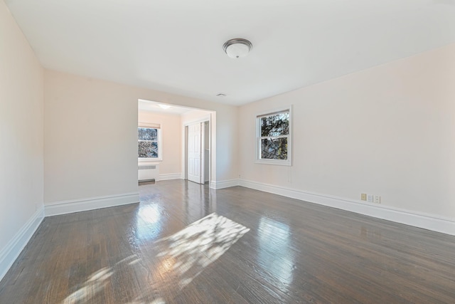 182-61 Avon Rd, Jamaica Estates, NY 11432 - spare room with dark wood-type flooring and radiator