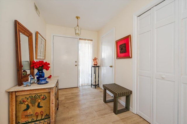 foyer featuring visible vents and light wood-style flooring