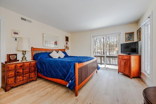 bedroom with access to exterior, light wood-style flooring, and visible vents