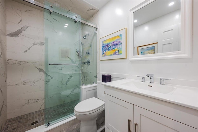 bathroom featuring vanity, a marble finish shower, and toilet