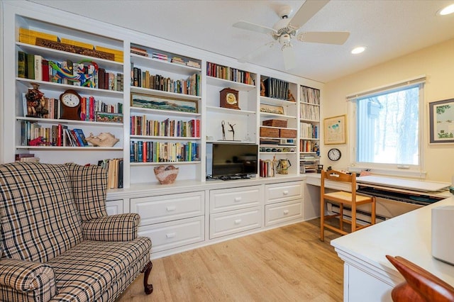 sitting room featuring a ceiling fan, recessed lighting, built in study area, and light wood-style flooring