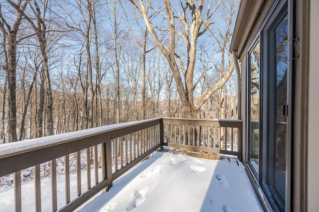 view of snow covered back of property