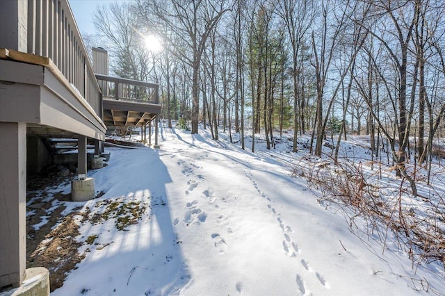 snowy yard featuring a sunroom