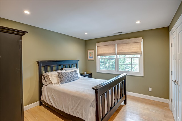 bedroom with recessed lighting, visible vents, light wood-style flooring, and baseboards