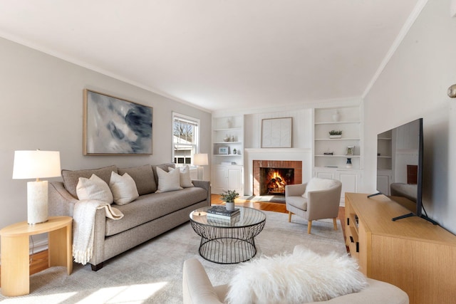 living room featuring a brick fireplace, built in features, and ornamental molding