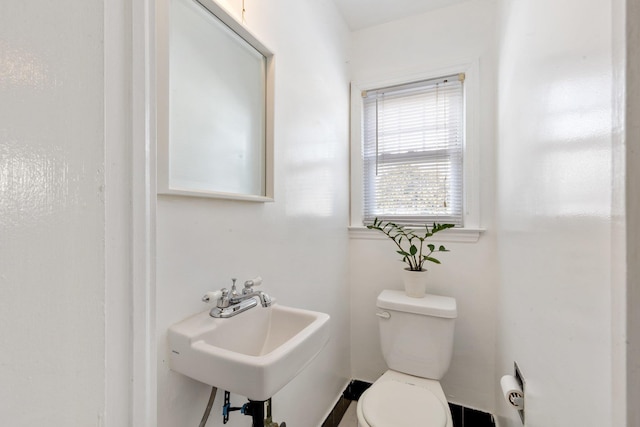 half bathroom featuring a sink and toilet