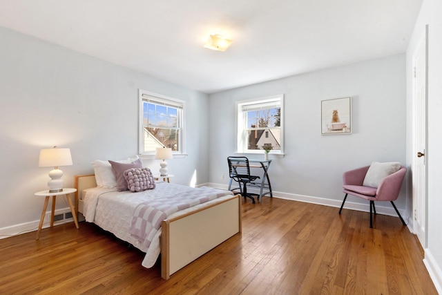 bedroom with wood finished floors and baseboards