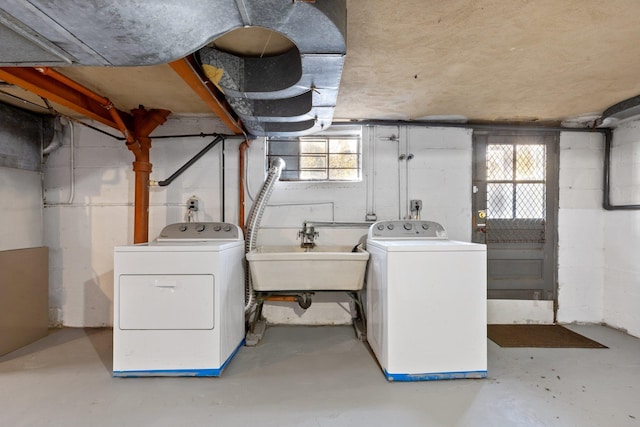 clothes washing area with a wealth of natural light, laundry area, independent washer and dryer, and a sink