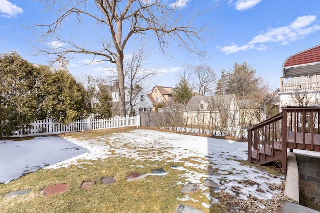 snowy yard featuring fence