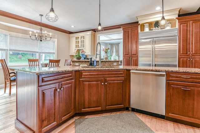 34 Clark Ln, Harriman, NY 10926 - kitchen featuring appliances with stainless steel finishes, a sink, light stone counters, ornamental molding, and a chandelier