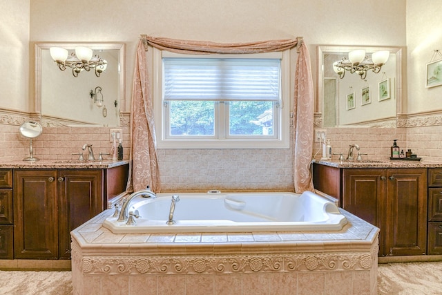 34 Clark Ln, Harriman, NY 10926 - full bathroom featuring a chandelier, two vanities, a bath, tile walls, and wainscoting